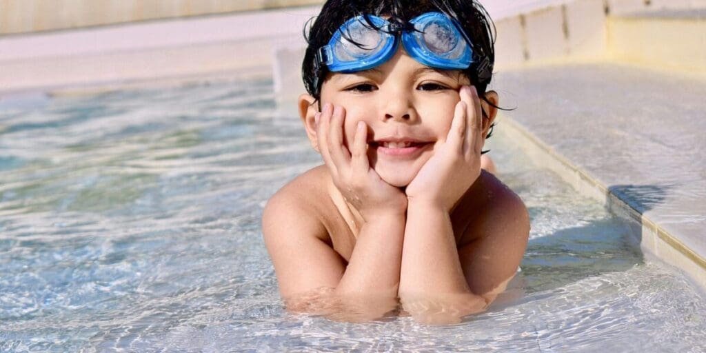 Young Boy in a Pool With Nice Clear Water - Home Pool Maintenance is Important