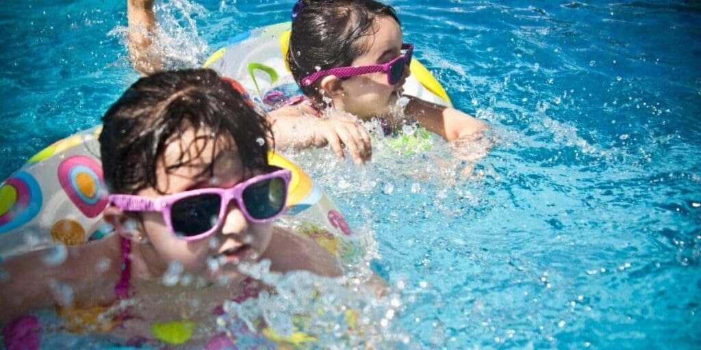 Young Girl's Swimming in Pool - Home Pool Water Maintenance Keeps Pool Ready to Swim